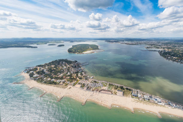 Aerial view of Sandbanks, Poole Harbour and Brownsea Island Aerial view of Poole Harbour and Brownsea Island and Dorset coastline on a sunny day. poole harbour stock pictures, royalty-free photos & images