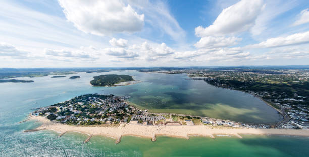 Aerial view of Sandbanks, Poole Harbour and Brownsea Island Aerial view of Poole Harbour and Brownsea Island and Dorset coastline on a sunny day. bournemouth england photos stock pictures, royalty-free photos & images