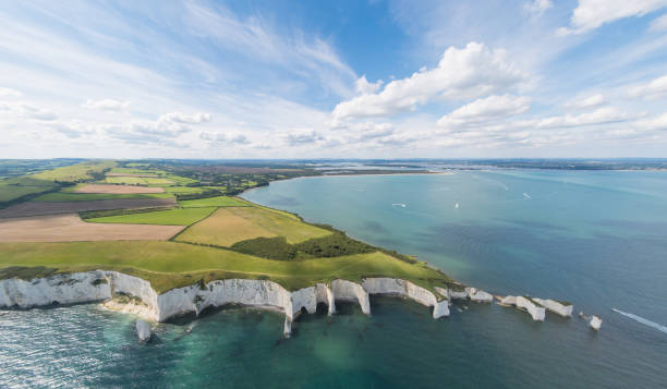 Aerial View of Old Harry Rocks and Purbeck Hills Aerial View of Old Harry Rocks and Purbeck Hills and Dorset coastline on a sunny day. old harry rocks stock pictures, royalty-free photos & images