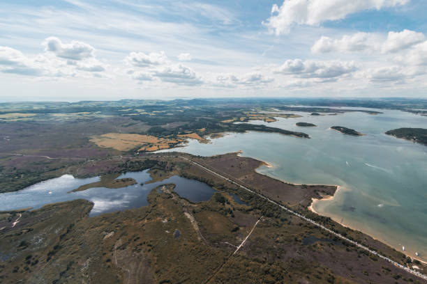 Aerial view of Poole Harbour and Studland Heath Aerial view of Poole Harbour and Studland Heath and Dorset coastline on a sunny day. studland heath stock pictures, royalty-free photos & images