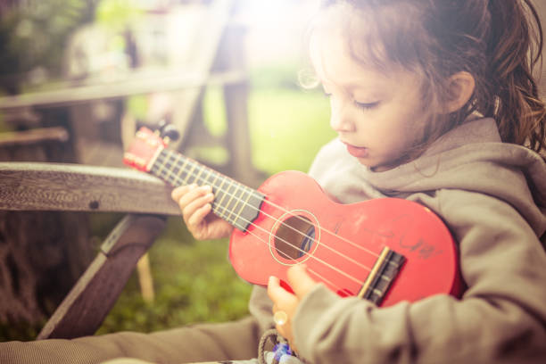 istock Little girl playing guitar 832200592