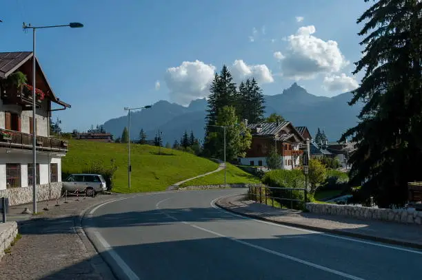 Photo of Autumnal corso Italia, the residential district in the town Cortina d'Ampezzo with meadow and mountain, Dolomite, Alps, Veneto