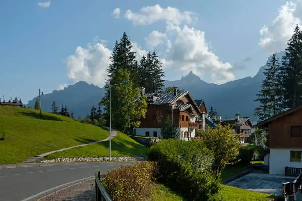 Photo of Autumnal corso Italia, the residential district in the town Cortina d'Ampezzo with meadow and mountain, Dolomite, Alps, Veneto