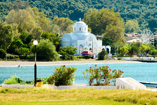 View of beach and white church in Kamena Vourla.Greece