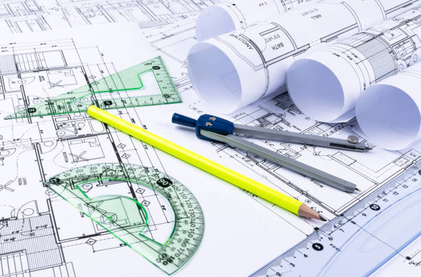 istock Architectural blueprints and blueprint rolls and a drawing instruments on the worktable. Drawing compass, plans. Civil Engineering, Construction background. 832242786
