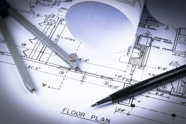 istock Architectural blueprints and blueprint rolls and a drawing instruments on the worktable. Drawing compass, plans. Civil Engineering, Construction background. 832243456