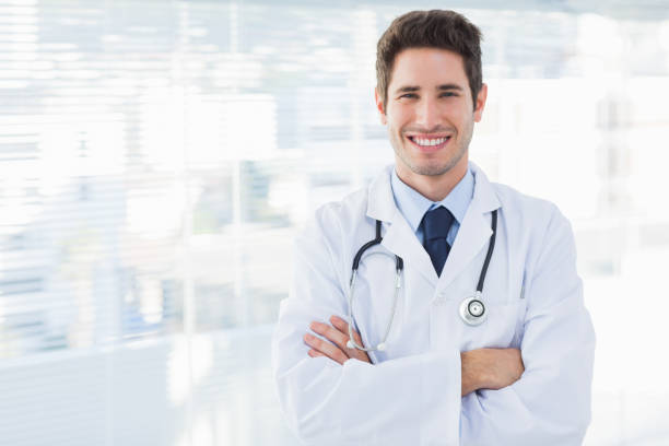 istock Smiling doctor crossed his arms and looking at camera 832266932