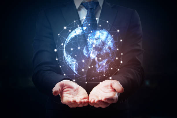 Network concept Businessman holding abstract glowing polygonal globe on dark background. Network concept. 3D Rendering man holding earth stock pictures, royalty-free photos & images