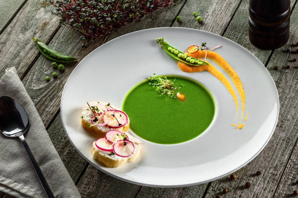 istock Pea cream soup in rim soup plate 832279896