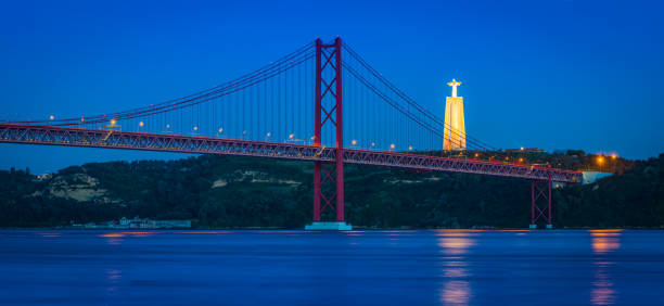istock Lisbon 25 de Abril bridge over Tagus illuminated dusk Portugal 832280850