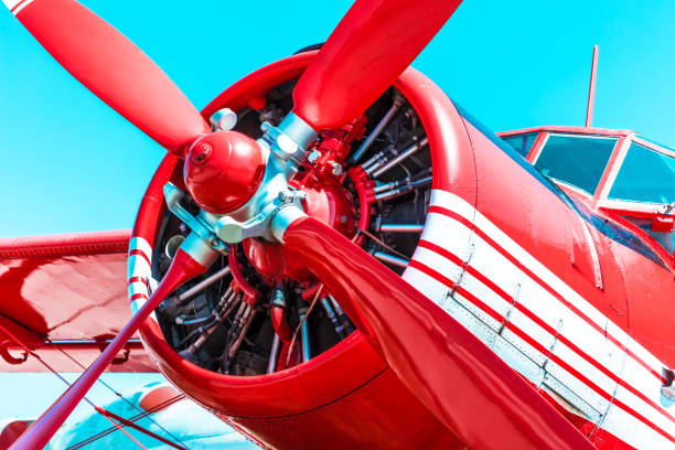 Red retro propeller engine airplane Creative abstract aviation industry, travel and adventure business concept: red retro propeller engine airplane against blue sky airplane commercial airplane propeller airplane aerospace industry stock pictures, royalty-free photos & images