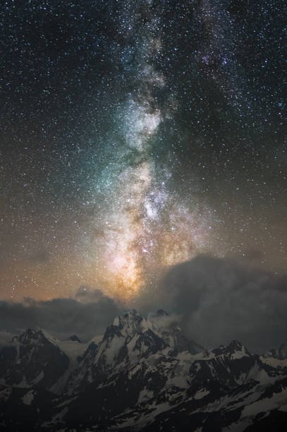 istock Milky Way leaving in clouds over Mount Ushba in the Caucasus 832285118