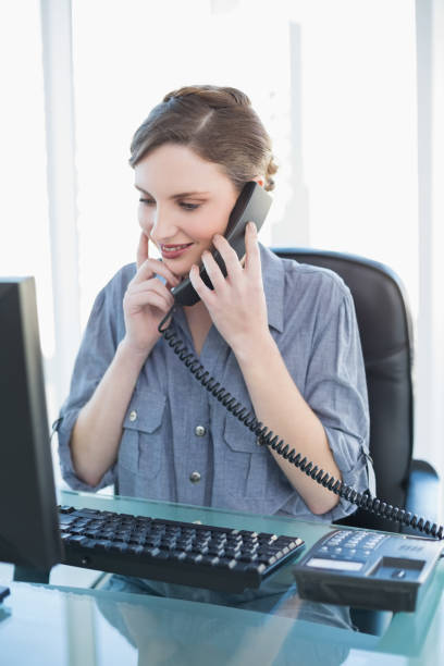istock Thinking young businesswoman phoning while sitting a desk 832291834