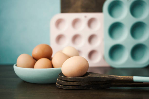 Pastels. Zen in the kitchen. Pastel colored kitchen equipment with eggs Zen in the kitchen. Pastel colored kitchen equipment with eggs muffin tin eggs stock pictures, royalty-free photos & images