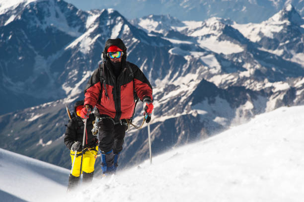 istock The climber climbs the snow-covered summit 832324218