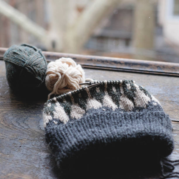istock Unfinished knitted cap on knitting needles 832350058