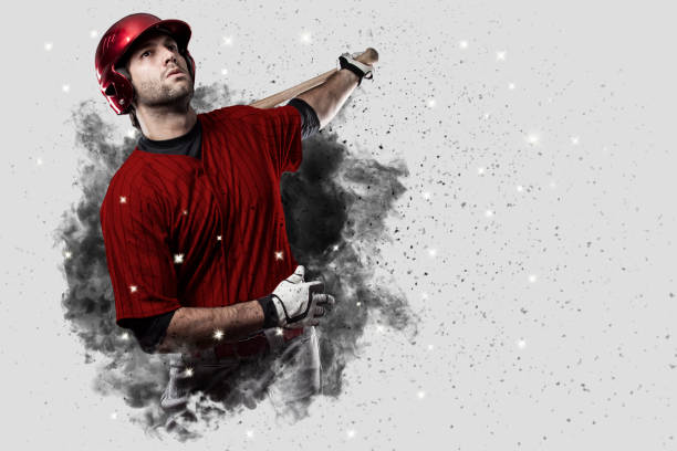 Baseball Player Baseball Player with a red uniform coming out of a blast of smoke . baseball hitter stock pictures, royalty-free photos & images