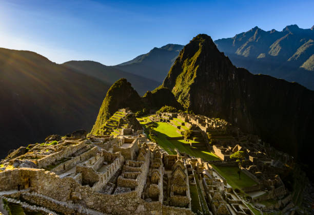 View of Machu Picchu as seen from the Inca Trail High angle view of the ancient Inca ruins of Machu Picchu as seen from the approach along the Inca trail. Mount Huayna Picchu is in the background. machu picchu photos stock pictures, royalty-free photos & images