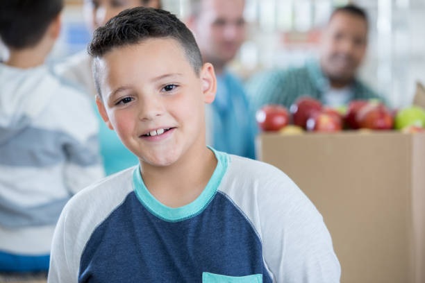 istock Cheerful boy helps out during food drive 832447848