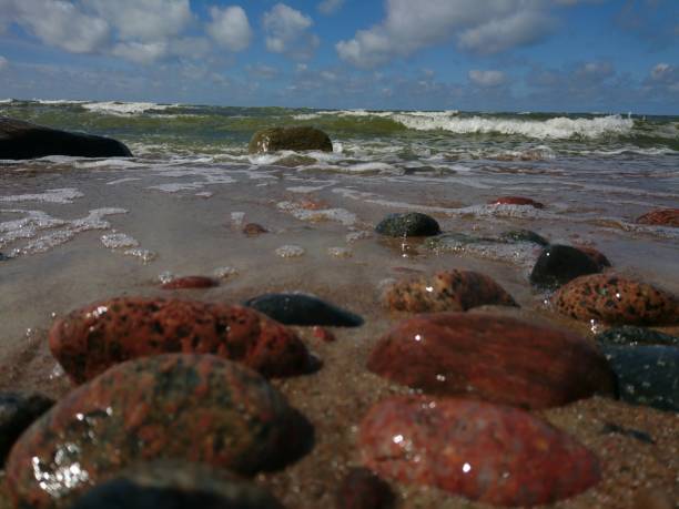 istock Coming waves to the stonely beach 832465888