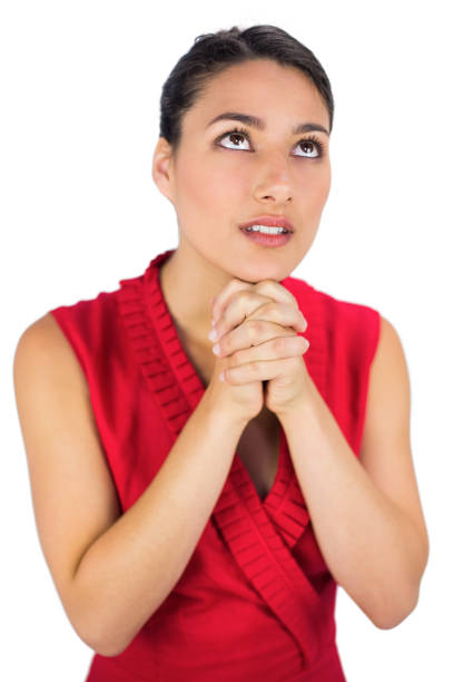 istock Beautiful brunette in red dress praying 832470266