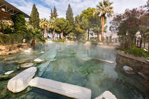 Thermal pool with ruins, Pamukkale, Turkey Historical thermal pool with roman ruins in Pamukkale, Turkey. thermal pool stock pictures, royalty-free photos & images