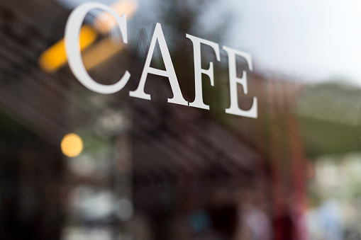 Selective focus on Cafe letters with blurred interior background