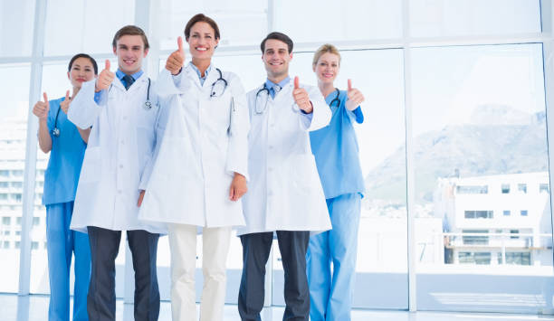 istock Doctors gesturing thumbs up at hospital 832513478