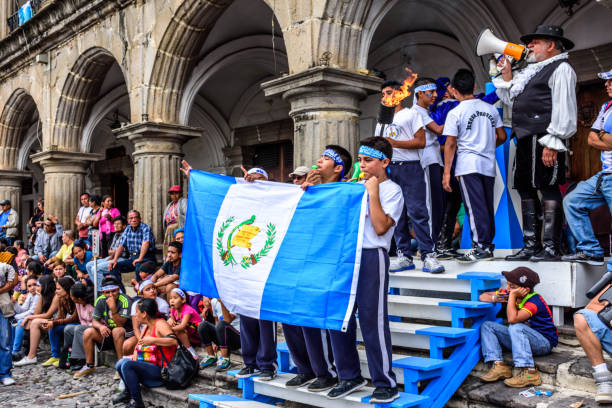 Posing for photos, Independence Day, Antigua, Guatemala Antigua, Guatemala - September 14, 2015: Locals pose for photos with Guatemalan flag & lit torch outside city hall during Guatemalan Independence Day celebrations puerto quetzal guatemala stock pictures, royalty-free photos & images