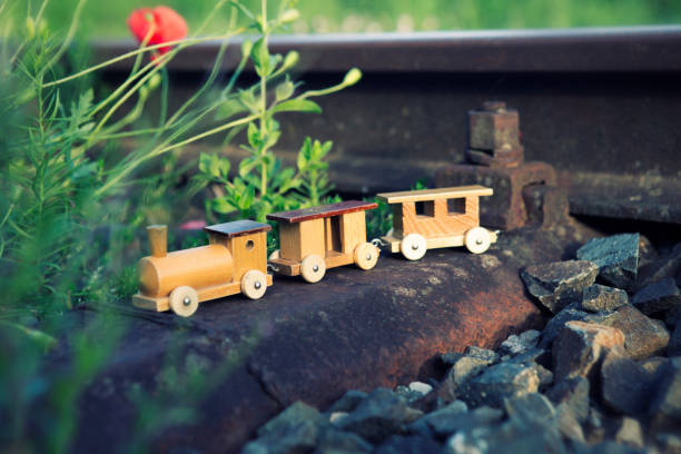 istock wooden toy train on real railway tracks 832523984