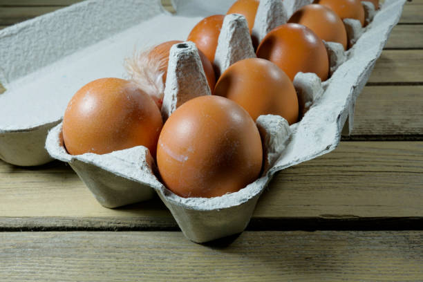 istock Farm chicken eggs in a cardboard box on a wooden rustic background 832530262