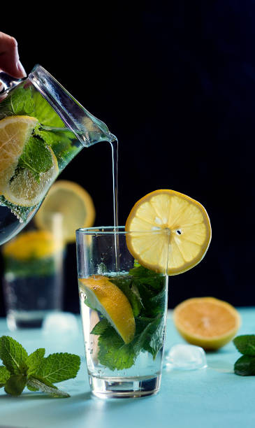 istock Mojito cocktail with lime and mint in glass on a grey stone background. Copy space 832539282