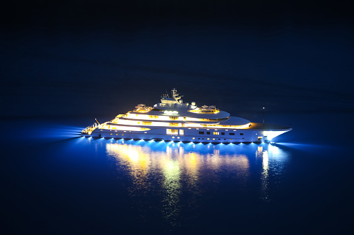 An illuminated luxury yacht in the Adriatiac sea at night in Dalmatia, Croatia.