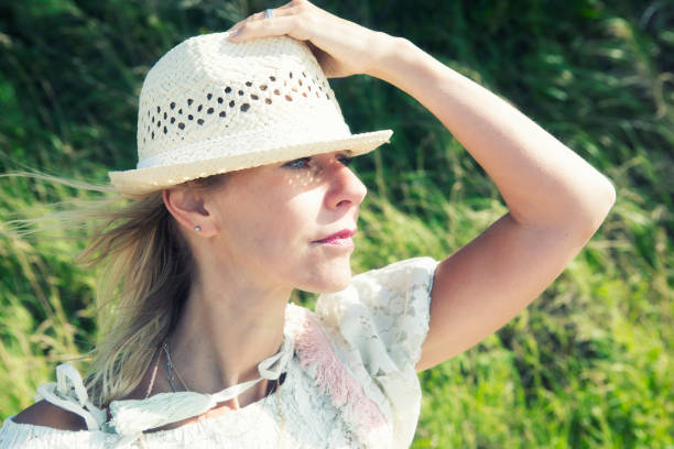 istock blond woman outdoors looking into the distance 832543824