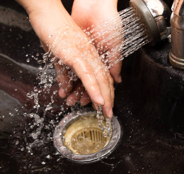 istock The man washes his hands in the sink 832544256