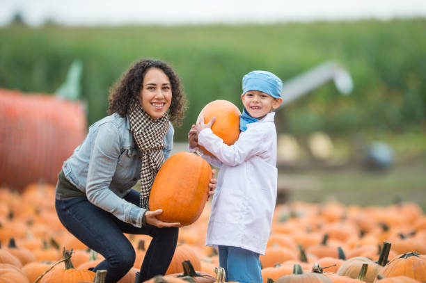 istock Family at pumpkin patch farm 832554026