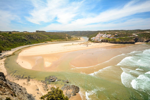 istock View from the cliffs to surfer beach Praia de Odeceixe, District Aljezur - Algarve Portugal 832566078