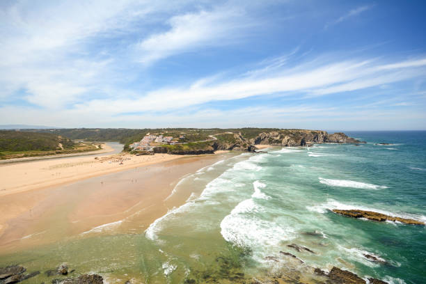 istock View from the cliffs to surfer beach Praia de Odeceixe, District Aljezur - Algarve Portugal 832566092