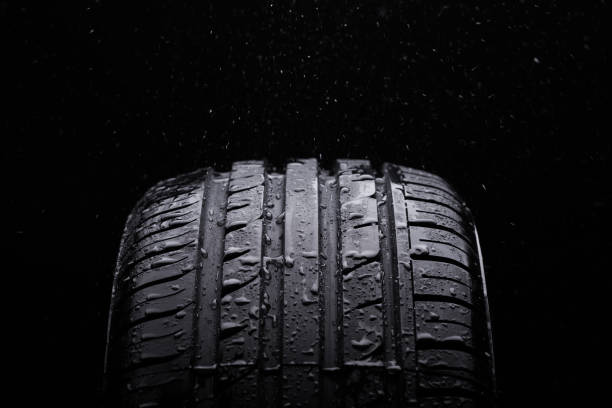 istock Water splashing on a new symmetrical tire during the rain 832566884