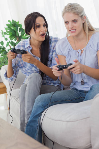 istock Young friends playing video games and having fun 832572258
