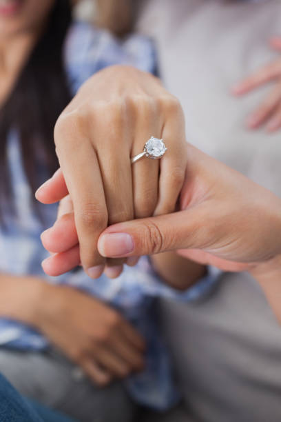 istock Close up of engagement ring on womans hand 832573662