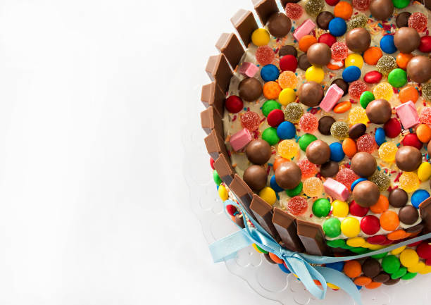 Pinata cake. Multicolored candies stuffed birthday cake with sweets inside. Copy space