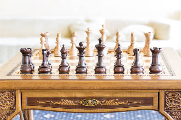 istock Wooden chess figures on a wooden   chessboard. 832580636