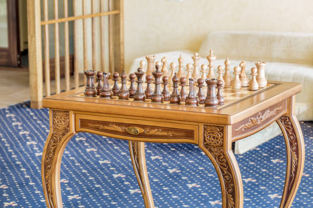 istock Wooden chess figures on a wooden   chessboard. 832580726