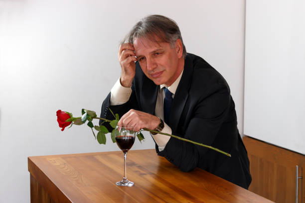 istock Handsome romantic man holding a rose and waiting for his wife. 832585256
