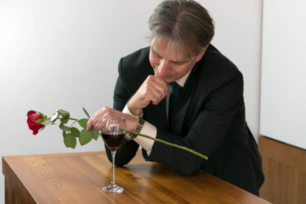 istock Handsome romantic man holding a rose and waiting for his wife. 832585514