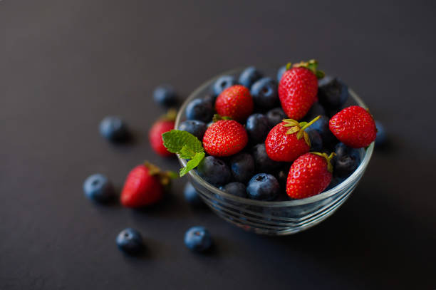 istock Mixed berries in a bowl : strawberries, raspberries, blueberries and blackberries. 832614294