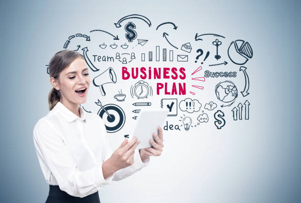 istock Happy blond woman with a tablet, business plan 832614700