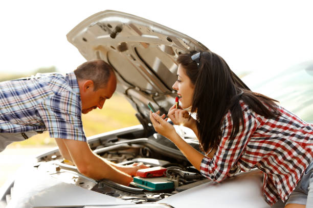 istock Woman applying lipstick while repairman works 832622696