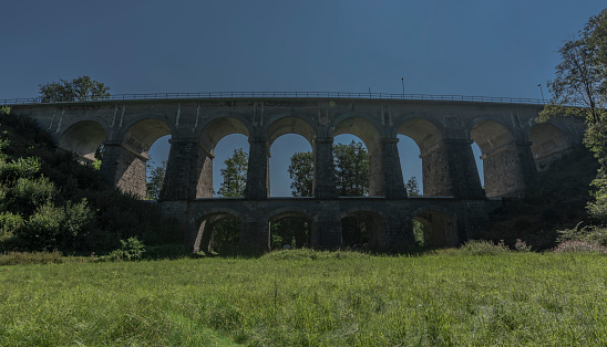 Stone rail viaduct near Sychrov village in north Bohemia summer hot day